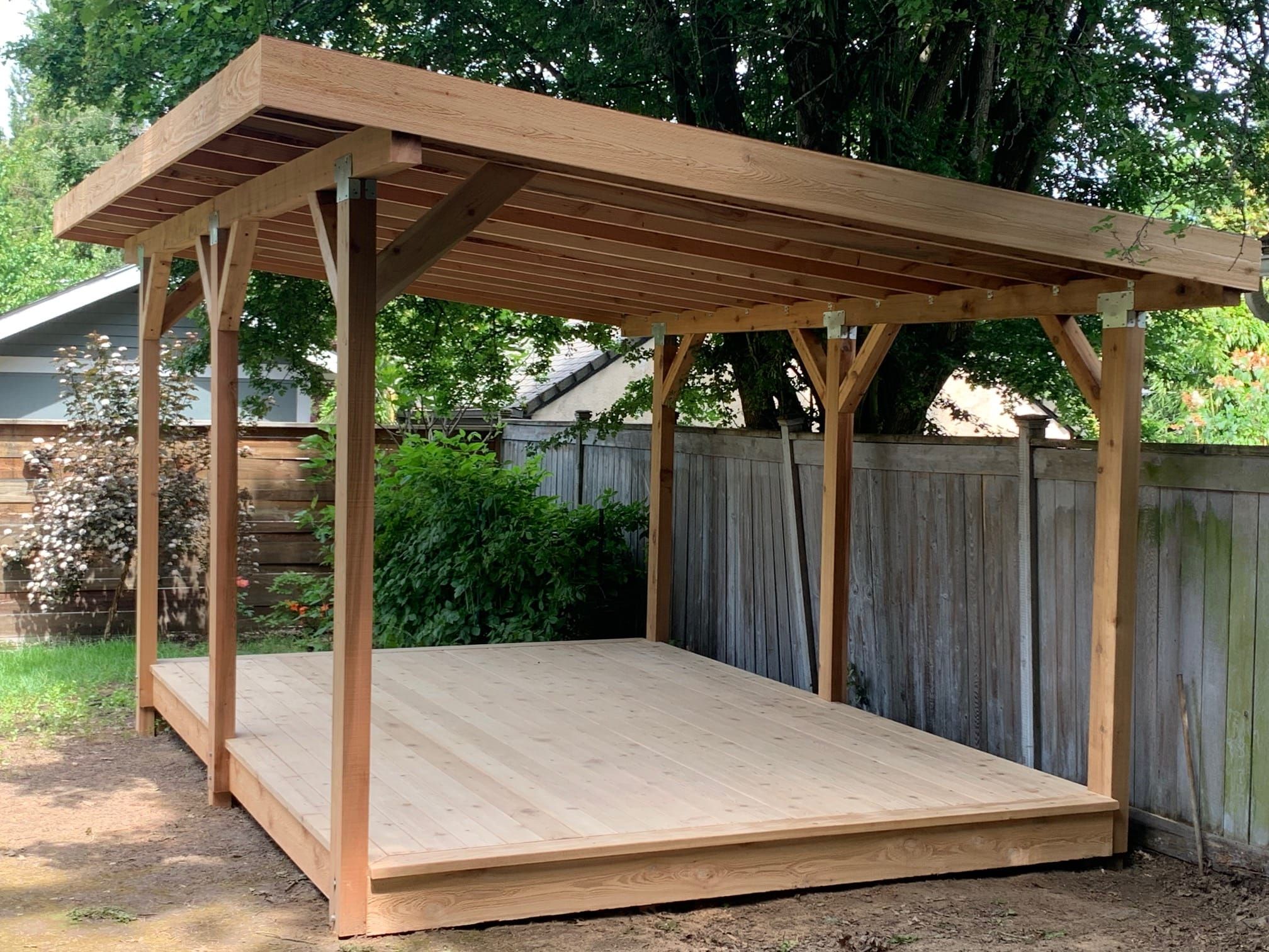 Freestanding cedar pavilion over a light deck platform
